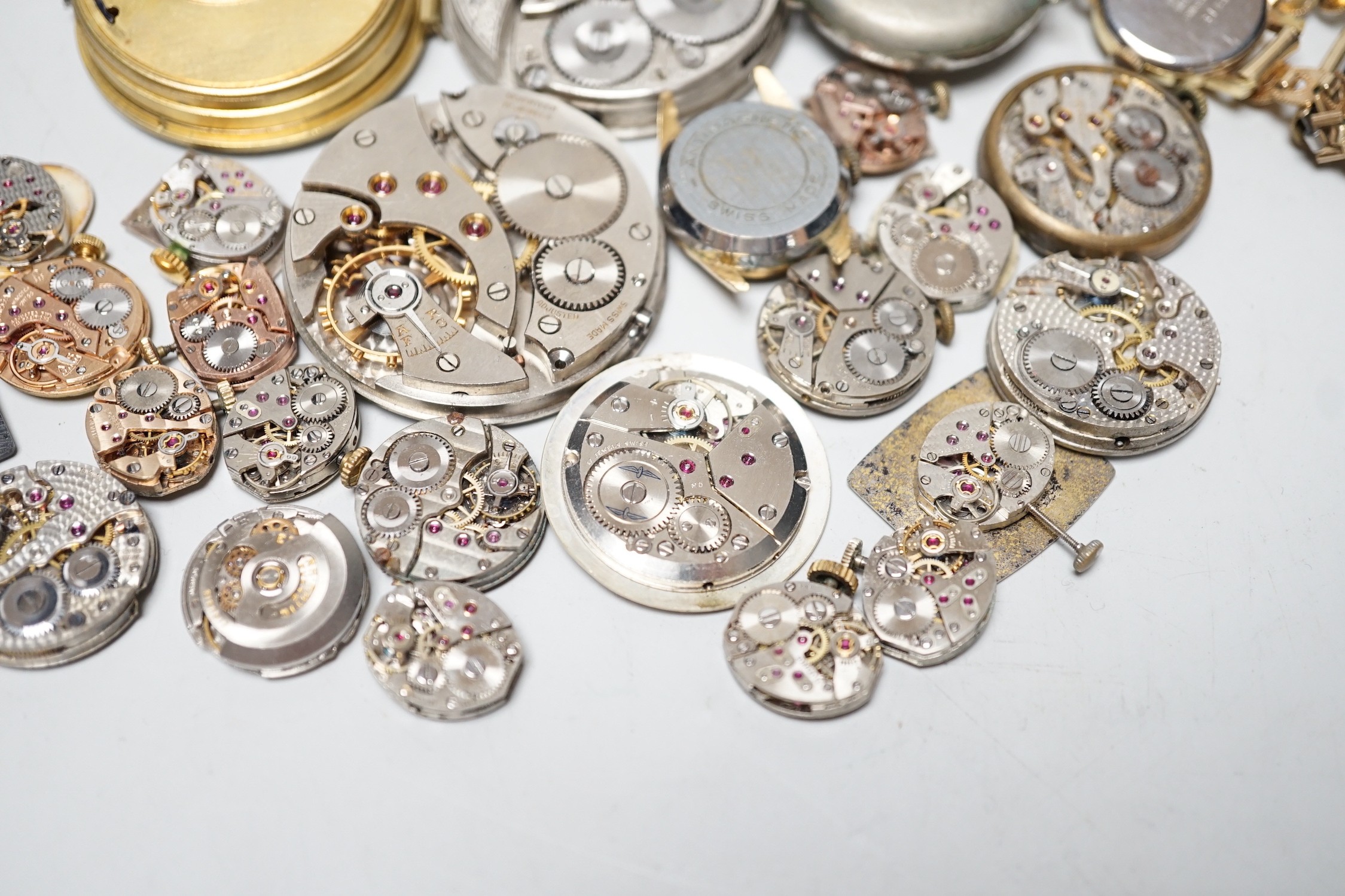 A collection of assorted wrist and pocket watch parts.
